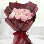 12 light pink rose bouquet wrapped in elegant paper - Dubai floral arrangements.