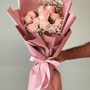 11 pastel pink roses bouquet wrapped in pink paper with ribbon