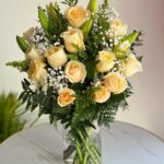 Sunshine flower arrangement with yellow roses, white lilies, and gypso in a glass vase