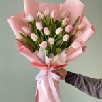 Blushing Pink Tulips bouquet wrapped in pink paper and white ribbon – Dubai flower delivery