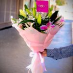 Queen of Heart bouquet with 5 pink lilies, gypsophila, and seasonal fillers in pink wrapping