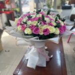 Galaxy of Roses bouquet with 50 pink roses and 50 white roses in white paper and pink ribbon