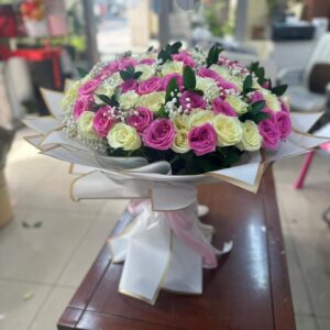 Galaxy of Roses bouquet with 50 pink roses and 50 white roses in white paper and pink ribbon