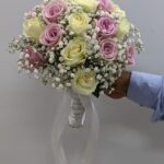 Classic Bridal Bouquet with pink roses, white roses, and gypsophila tied with a white ribbon