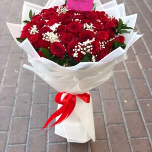 Romantic Date 100 red roses bouquet wrapped in white paper with red ribbon